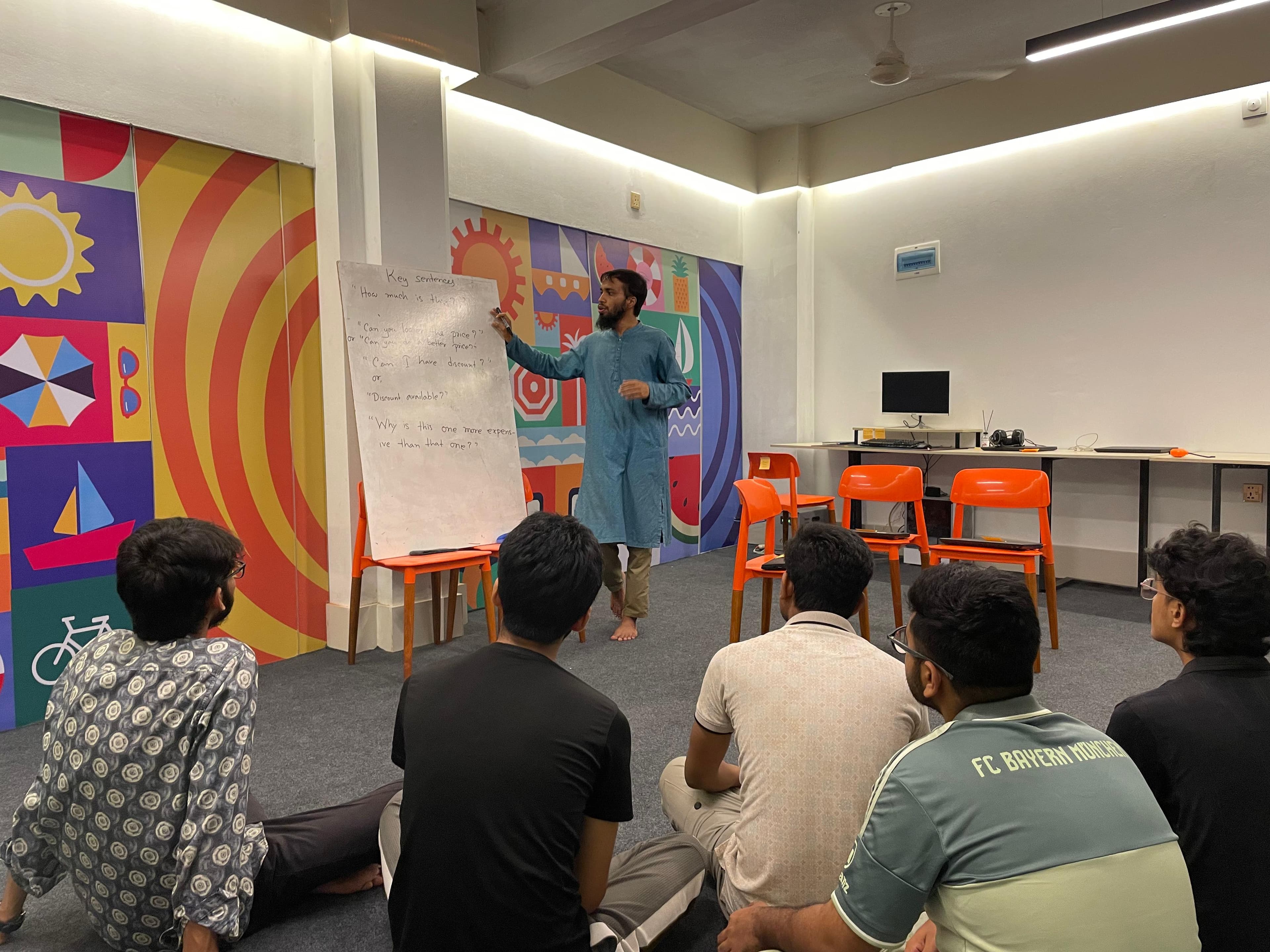 Student practicing English communication in front of a class